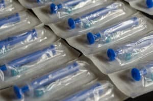 Group of new medical syringes. Blue Medical syringes in a package.  Medical syringes in packaging as an abstract background. Selective focus. Close-up.