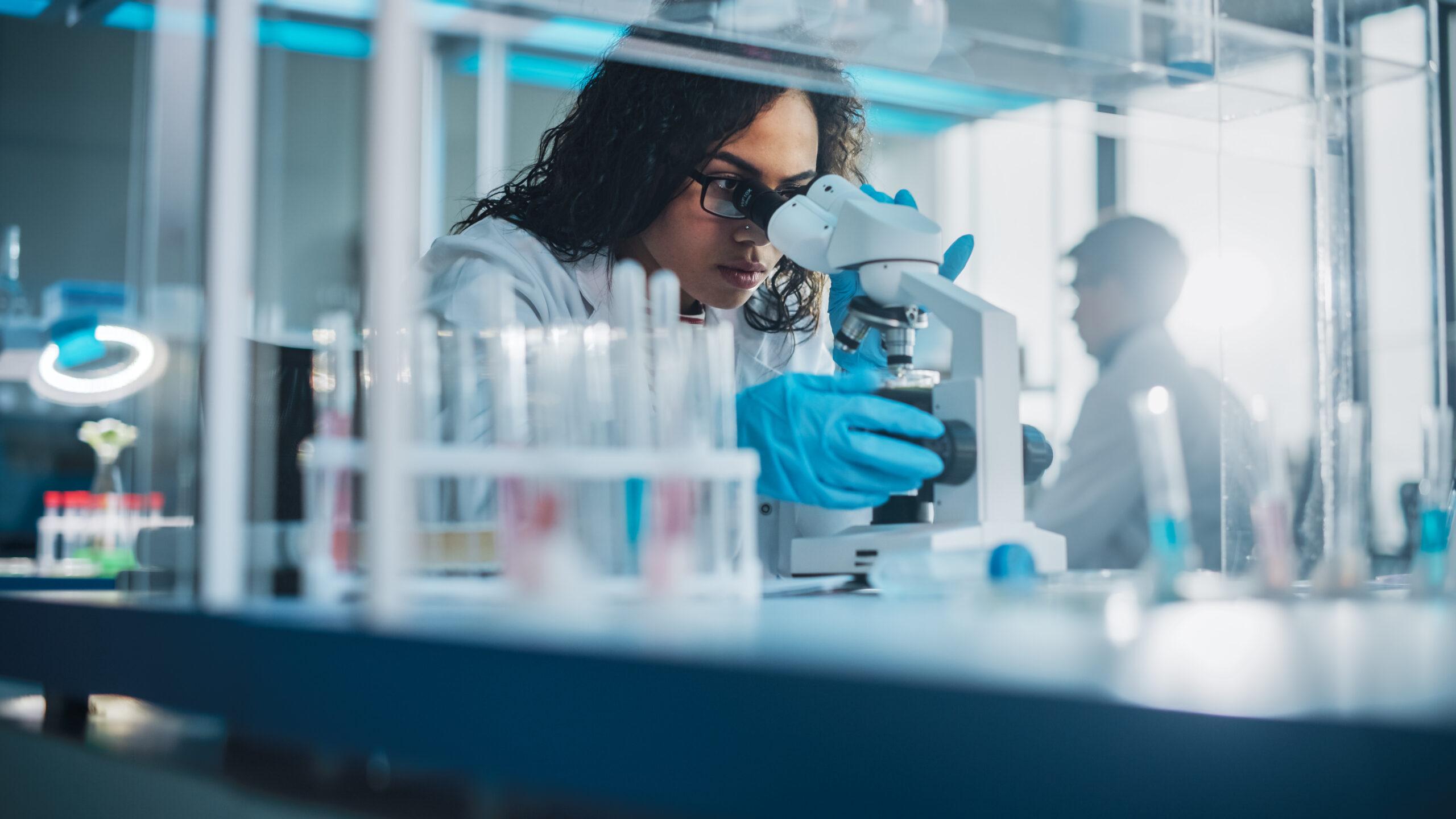 Women using a microscope in a lab