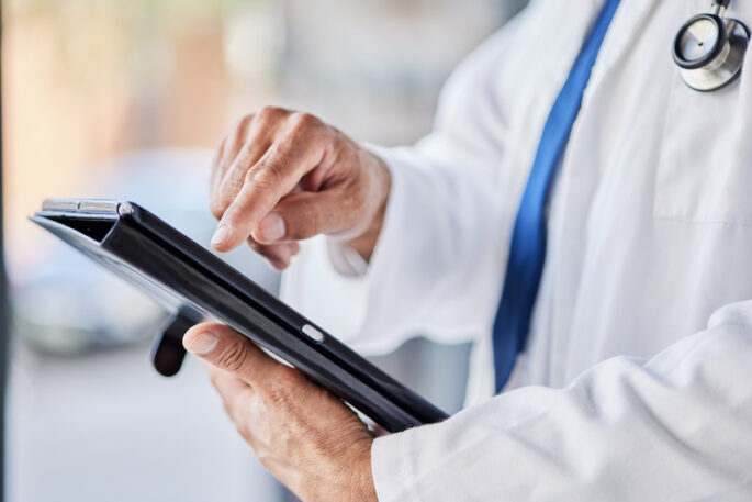 Tablet, doctor hands and person for healthcare information, results and online research or clinic management software. Typing, search and medical worker with digital technology for health services