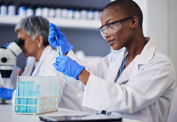 Science, black woman and pipette with tube for test, research and investigation in laboratory. Female scientist working with dropper to study liquid sample, review solution and innovation of vaccine