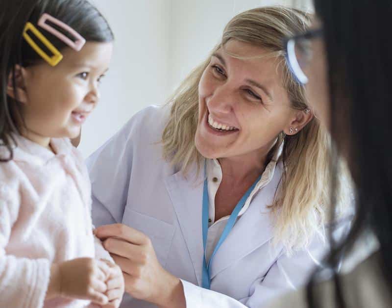 Pediatrician Examining A Little Girl