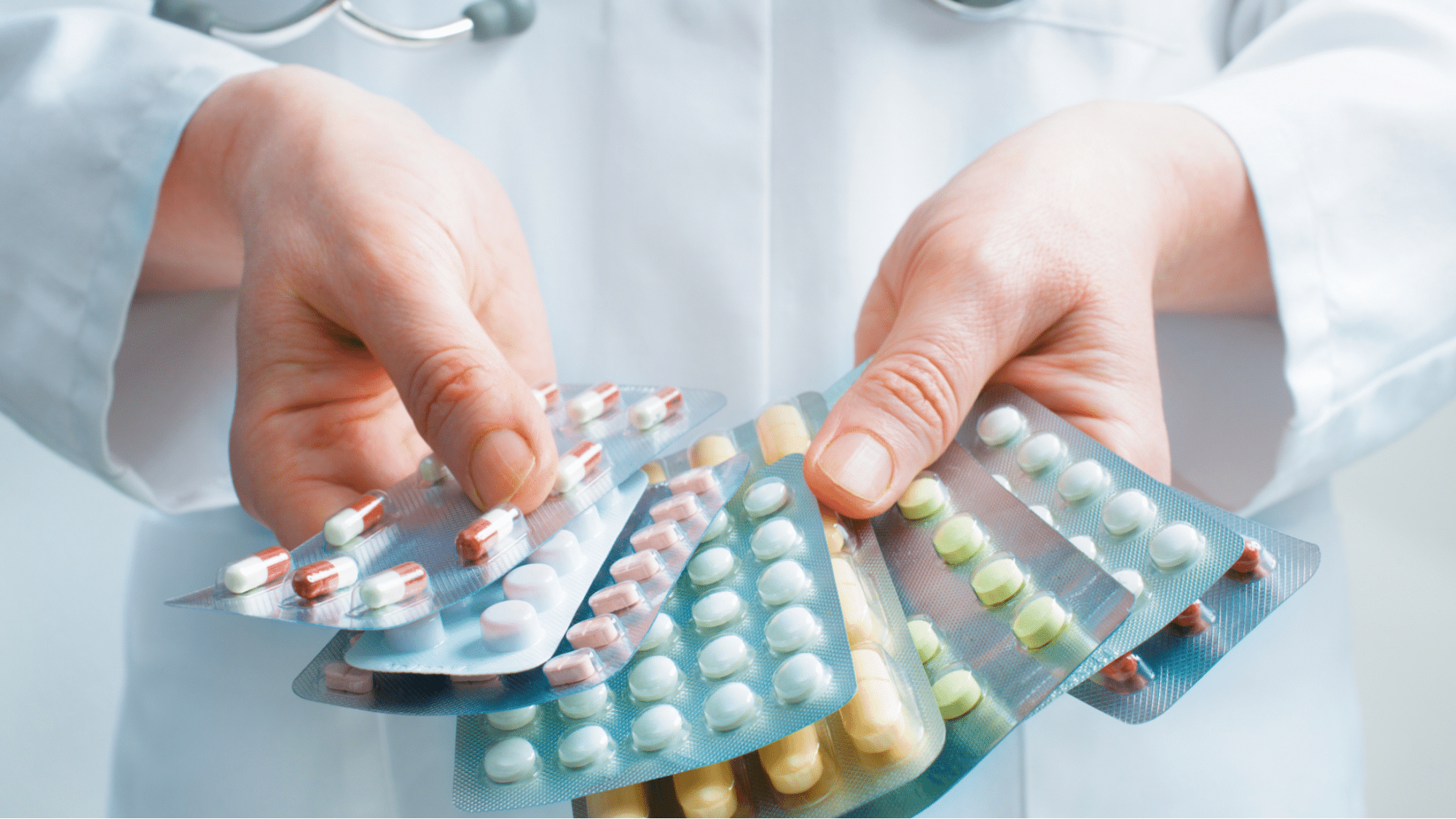 Pharmacist holding pill blistsers